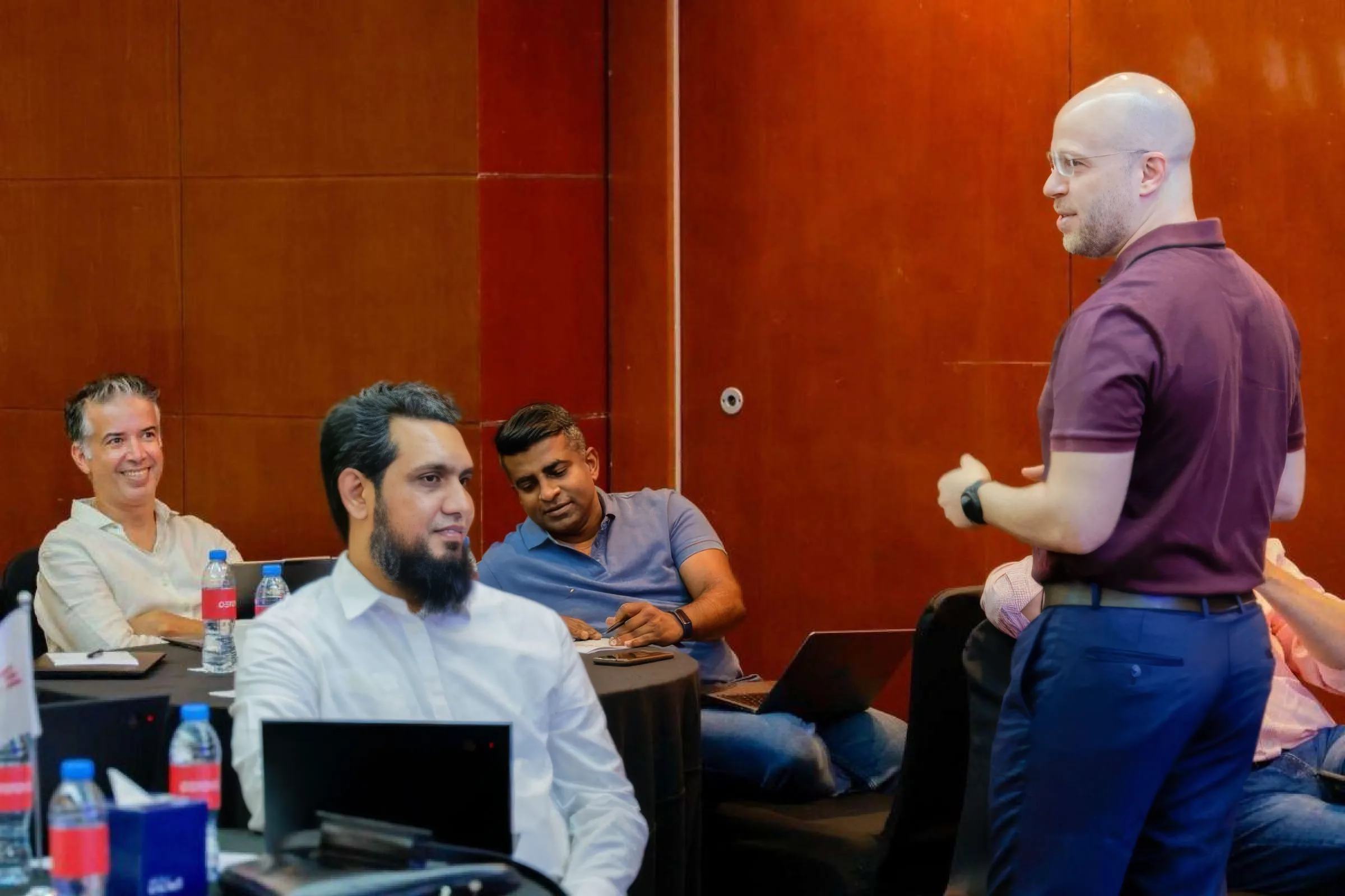 Fahed Bizzari leading a previous workshop with participants working at laptops